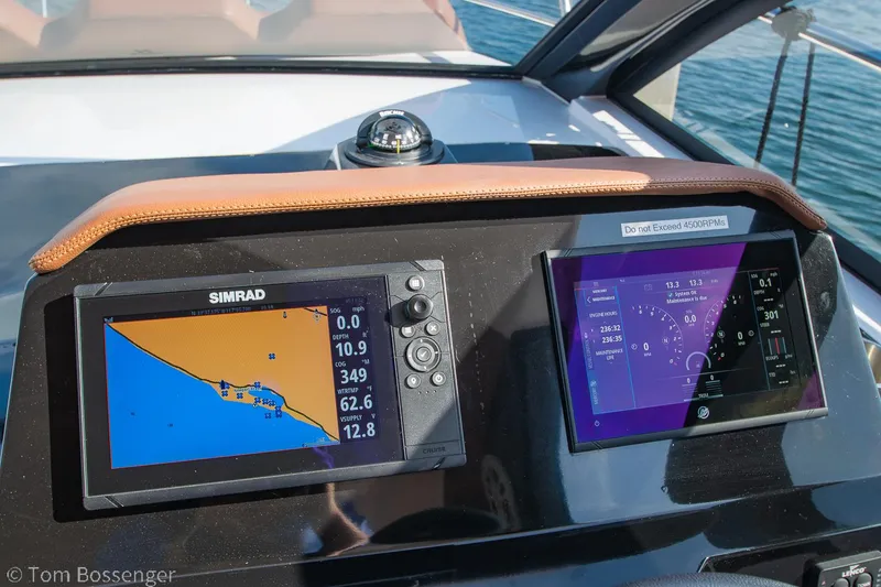 Slide: The Image of Dashboard of 2023 NX Boats 340 Sport Coupe with navigation screens and compass. - 16