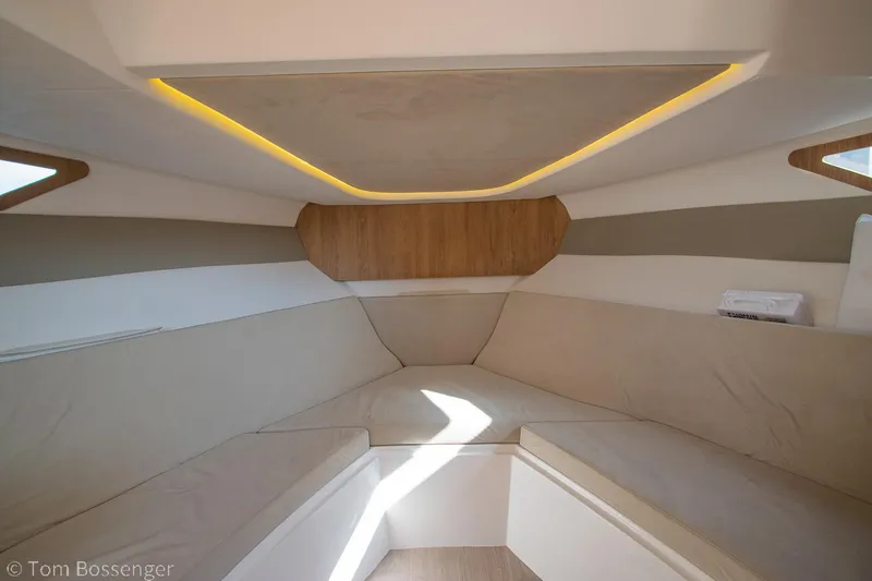 Slide: The Image of Interior of 2023 NX Boats 340 Sport Coupe, featuring modern seating and ambient lighting. - 20