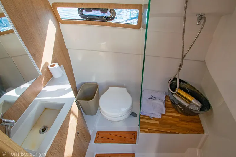 Slide: The Image of 2023 NX Boats 340 Sport Coupe bathroom with modern fixtures and wooden accents. - 25