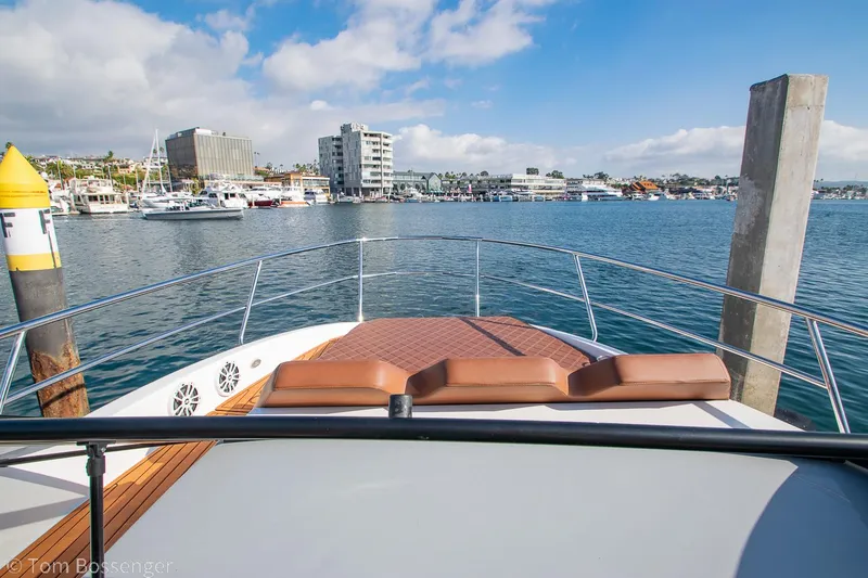 Slide: The Image of 2023 NX Boats 340 Sport Coupe on a scenic waterfront with city skyline. - 26