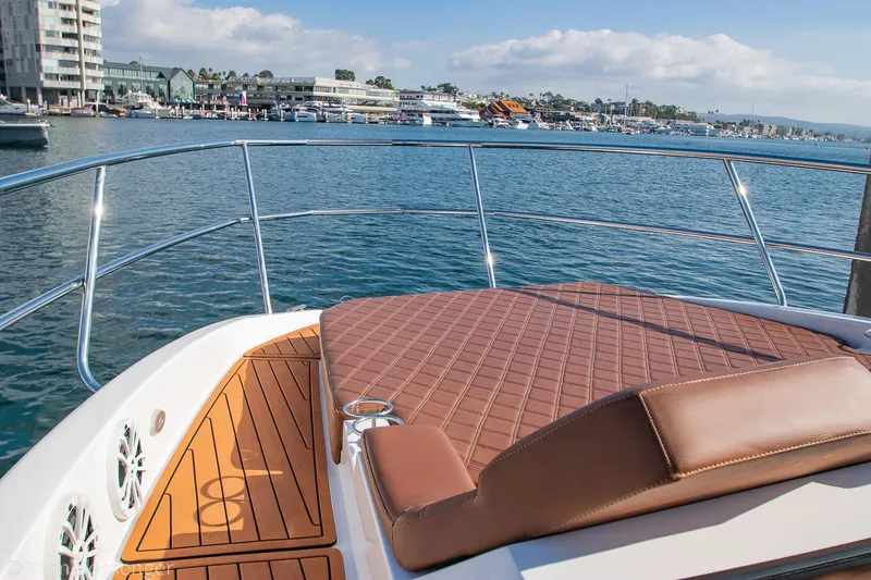 Slide: The Image of 2023 NX Boats 340 Sport Coupe, luxurious deck view, overlooking marina. - 27