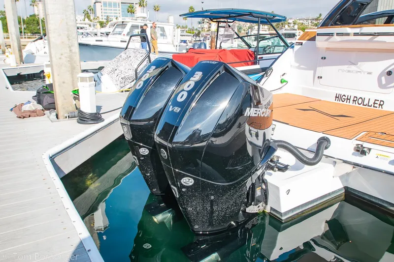 Slide: The Image of 2023 NX Boats 340 Sport Coupe with dual Mercury outboard engines docked at marina. - 30