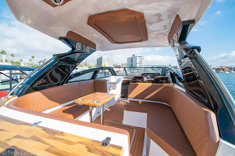 Slide: The Image of 2023 NX Boats 340 Sport Coupe interior with luxurious seating and modern design on the water. - 8