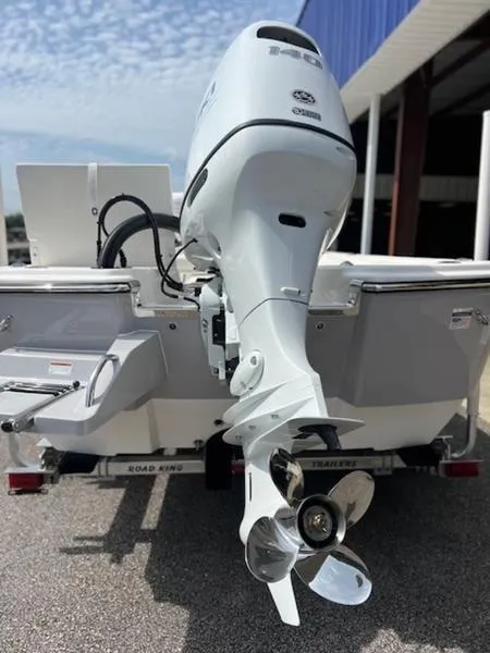 Slide: The Image of 2024 Sundance DX22 HPX boat with outboard motor, rear view. - 3