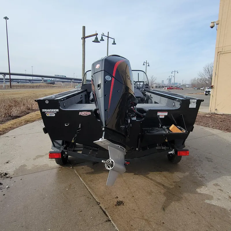 Slide: The Image of 2024 Tracker Targa V-18 WT boat on a trailer, rear view with outboard motor. - 2