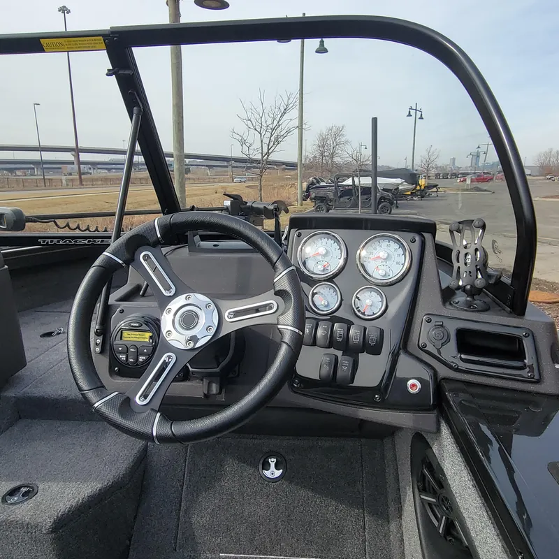 Slide: The Image of 2024 Tracker Targa V-18 WT boat dashboard with steering wheel and instrument panel. - 7