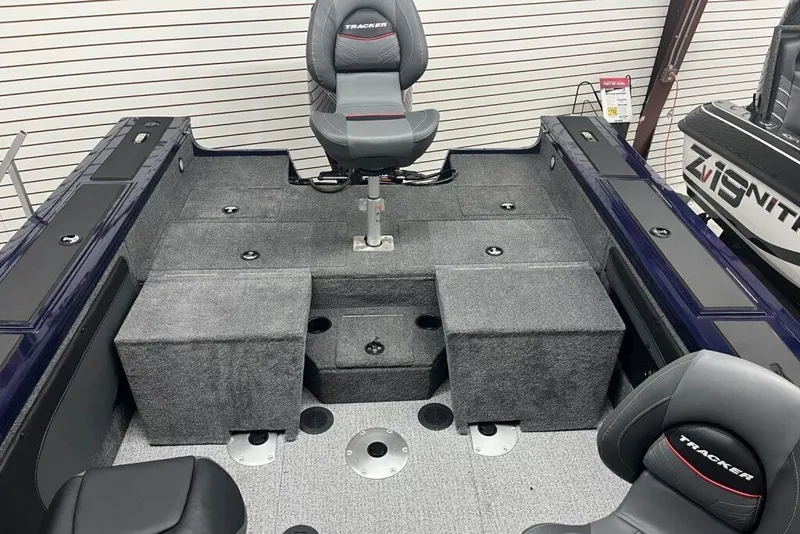 Slide: The Image of 2024 Tracker Targa V-19 Combo boat with powerful outboard motor, parked outdoors. - 2