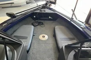 Slide: The Image of 2024 Tracker Targa V-19 Combo boat interior with seating and control console. - 8