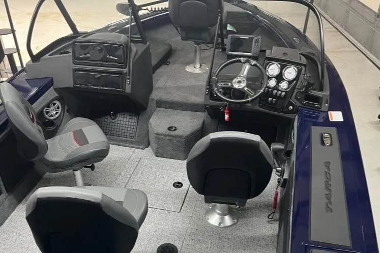 Slide: The Image of 2024 Tracker Targa V-19 Combo boat dashboard with steering wheel and gauges. - 9