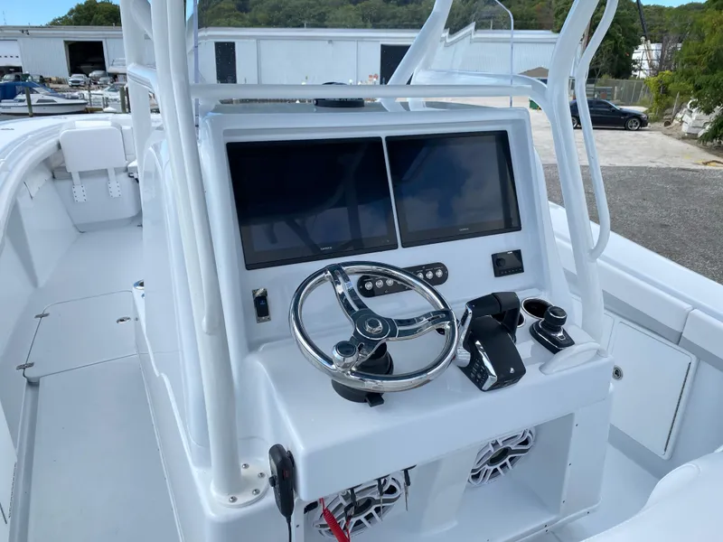 Slide: The Image of 2024 Yellowfin 36 Center Console boat helm with dual screens and steering wheel. - 12