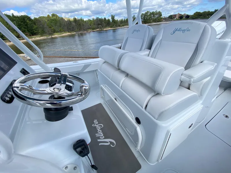 Slide: The Image of 2024 Yellowfin 36 Center Console boat interior with white seating and steering wheel. - 16
