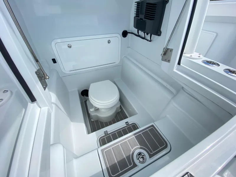 Slide: The Image of 2024 Yellowfin 36 Center Console boat interior with marine toilet and storage compartment. - 19