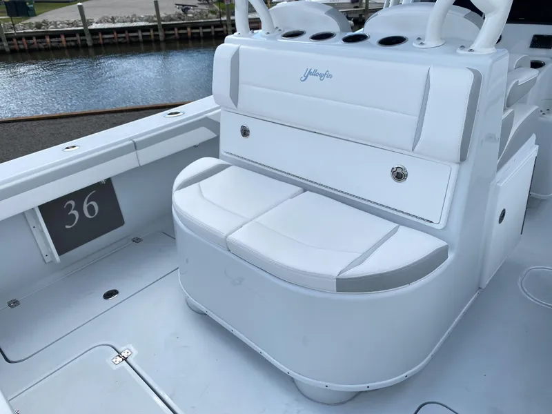 Slide: The Image of 2024 Yellowfin 36 Center Console boat interior with white seating and storage. - 8