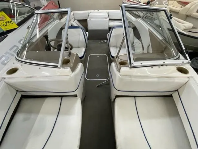 Slide: The Image of 2005 Bayliner Capri 195 interior with white seating and windshield. - 12