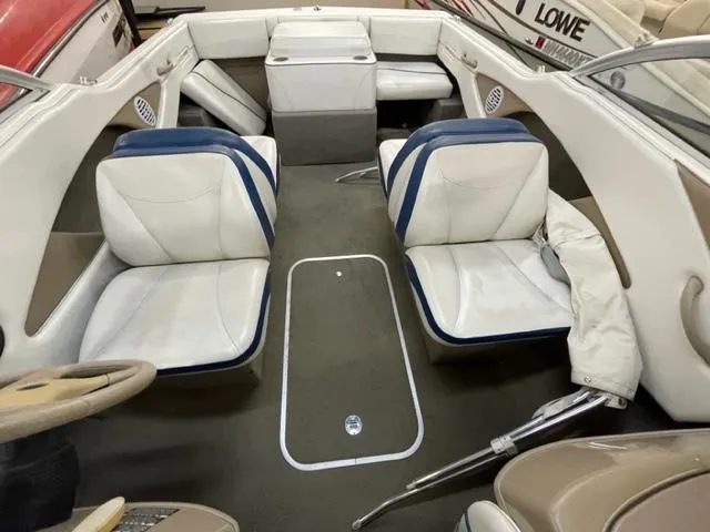 Slide: The Image of 2005 Bayliner Capri 195 boat interior with white and blue seating. - 13