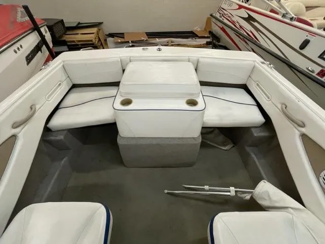 Slide: The Image of 2005 Bayliner Capri 195 boat interior with white seating and cup holders. - 14