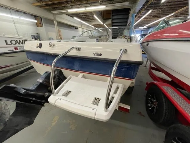 Slide: The Image of 2005 Bayliner Capri 195 boat in indoor storage, rear view with swim platform. - 3