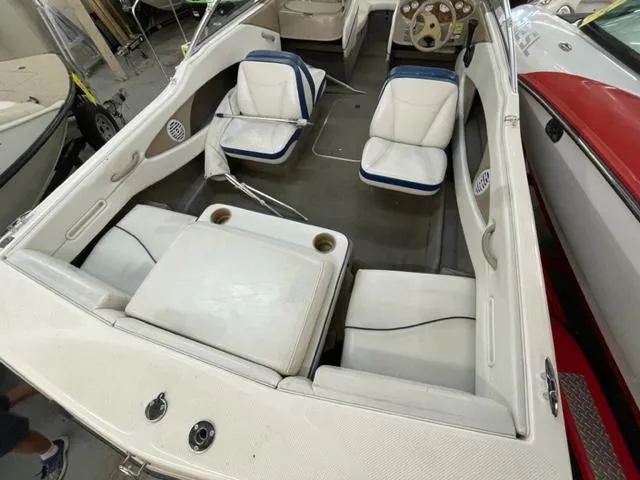 Slide: The Image of 2005 Bayliner Capri 195 boat interior with white and blue seating. - 5