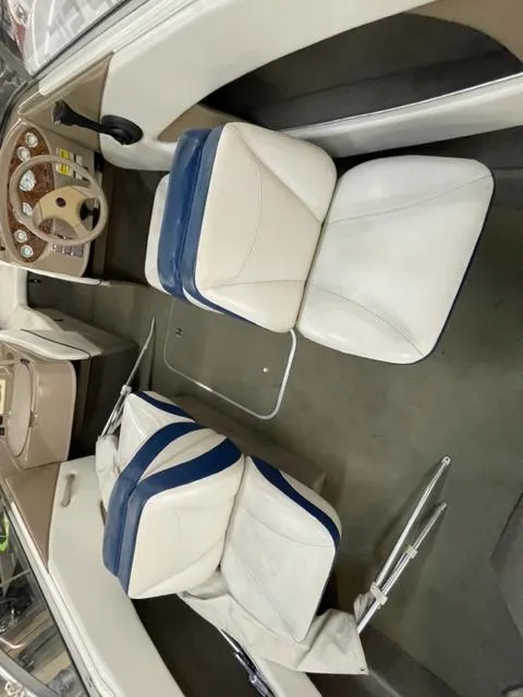 Slide: The Image of Interior of 2005 Bayliner Capri 195 boat with white and blue seats. - 6