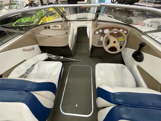Slide: The Image of 2005 Bayliner Capri 195 interior, featuring white and blue seating, steering wheel, and dashboard. - 7