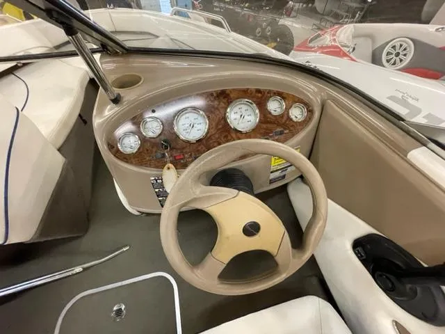 Slide: The Image of 2005 Bayliner Capri 195 boat dashboard with steering wheel and gauges. - 8