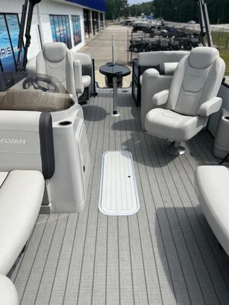 Slide: The Image of 2023 Sylvan Mirage X X1 pontoon boat interior with plush seating and modern design. - 3