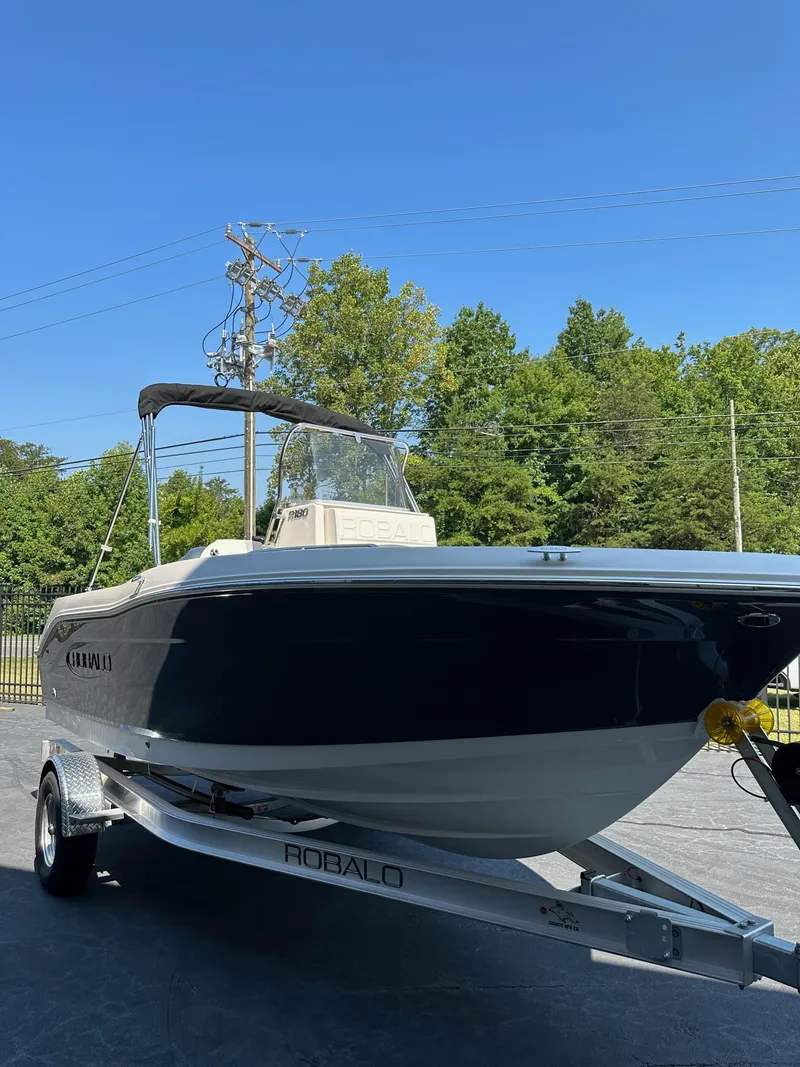 Slide: The Image of 2023 Robalo R180 Center Console boat on trailer, side view. - 2