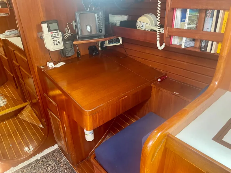 Slide: The Image of Navigation station in 1983 Bristol 45.5 Center Cockpit sailboat with wooden desk and communication equipment. - 18
