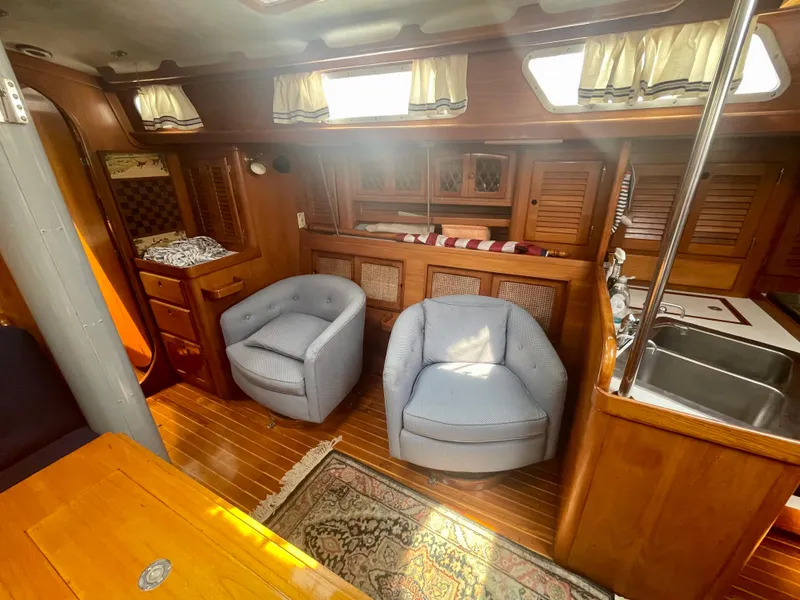 Slide: The Image of Interior of 1983 Bristol 45.5 Center Cockpit yacht with cozy seating and wooden cabinetry. - 21