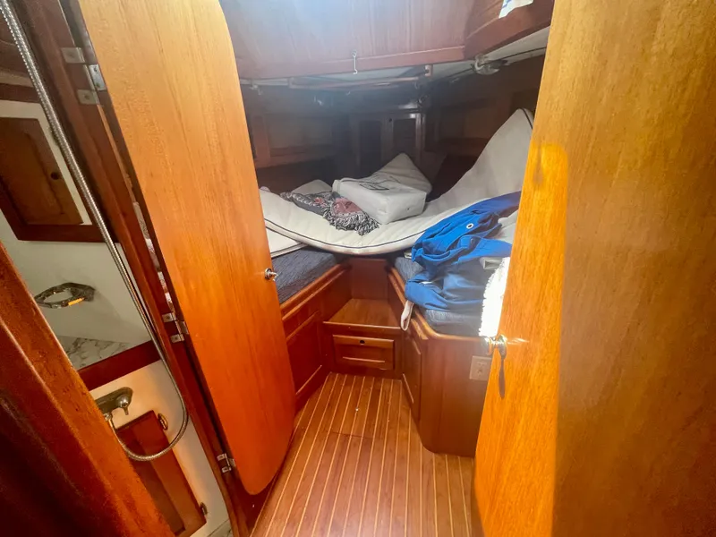 Slide: The Image of 1983 Bristol 45.5 Center Cockpit interior cabin with wooden finish and cozy bedding. - 22