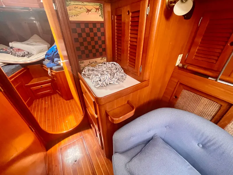 Slide: The Image of Interior of 1983 Bristol 45.5 Center Cockpit sailboat with wooden cabinetry and cozy seating. - 23