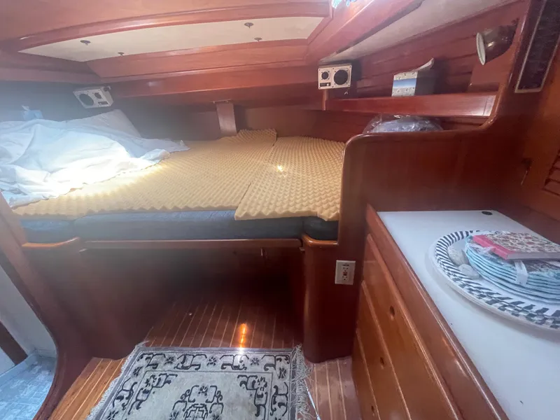 Slide: The Image of 1983 Bristol 45.5 Center Cockpit interior cabin with bed and wooden furnishings. - 30