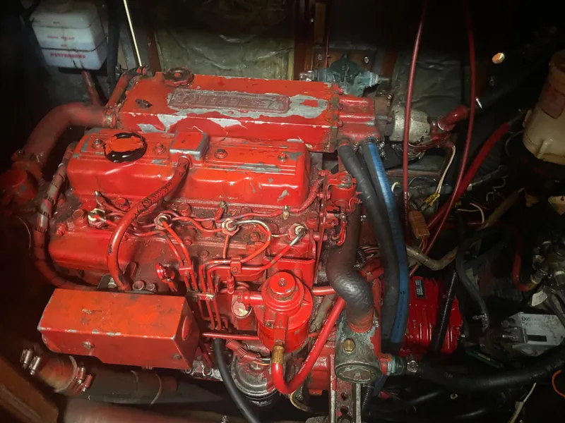 Slide: The Image of 1983 Bristol 45.5 Center Cockpit engine compartment with red engine and wiring. - 33