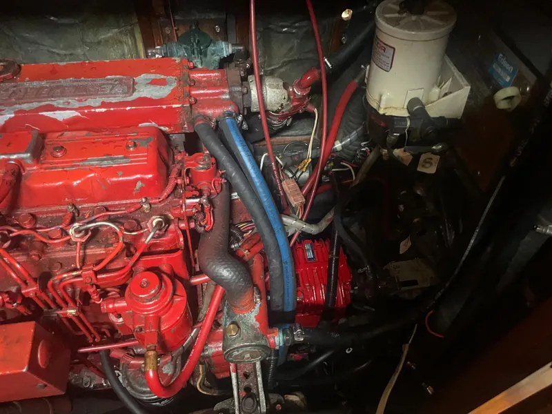 Slide: The Image of 1983 Bristol 45.5 Center Cockpit engine compartment with red engine and hoses. - 34