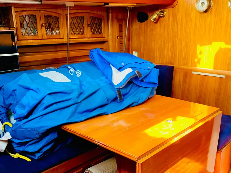 Slide: The Image of Interior of 1983 Bristol 45.5 Center Cockpit sailboat with blue sail cover on table. - 36