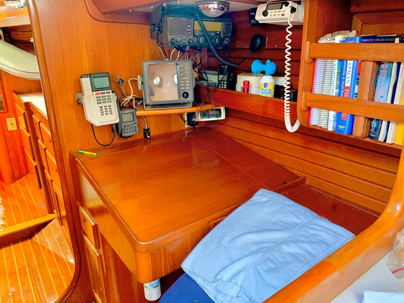 Slide: The Image of Navigation station on a 1983 Bristol 45.5 Center Cockpit sailboat with communication equipment. - 37