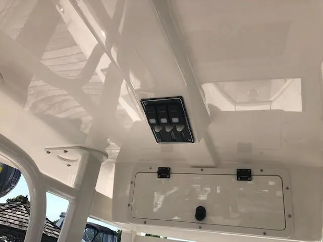 Slide: The Image of 2023 NauticStar 24 XS boat interior ceiling with control panel. - 15