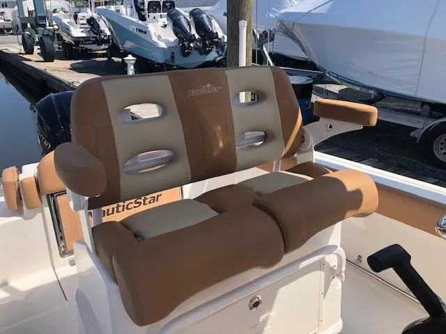 Slide: The Image of 2023 NauticStar 24 XS boat with tan and beige cushioned seating. - 6