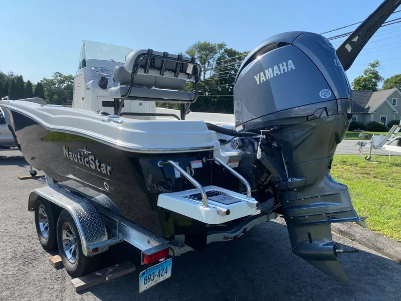 Slide: The Image of 2024 NauticStar 211 Hybrid boat with Yamaha outboard motor on trailer. - 3