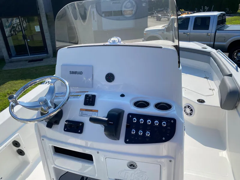 Slide: The Image of 2024 NauticStar 211 Hybrid boat console with steering wheel and control panel. - 6