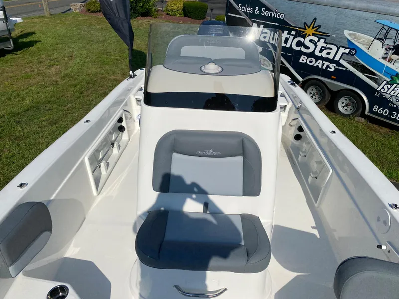 Slide: The Image of 2024 NauticStar 211 Hybrid boat interior with seating and console. - 8