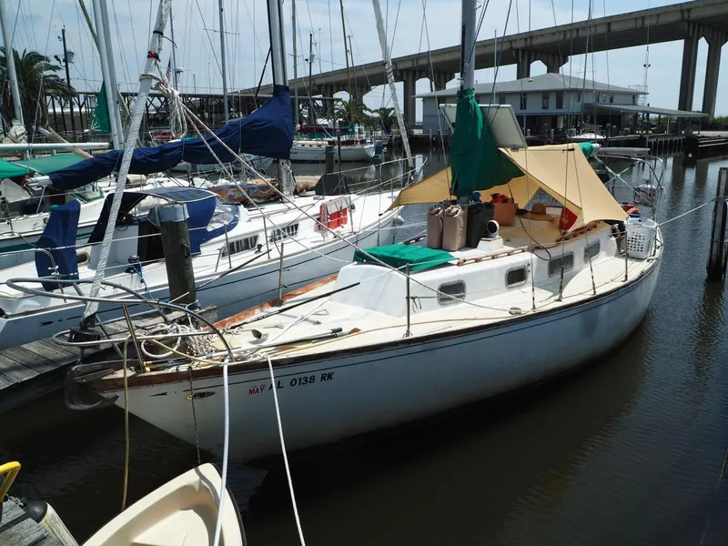 The Image of 1971 Tartan 34C sailboat docked in a marina, surrounded by other boats. - 1