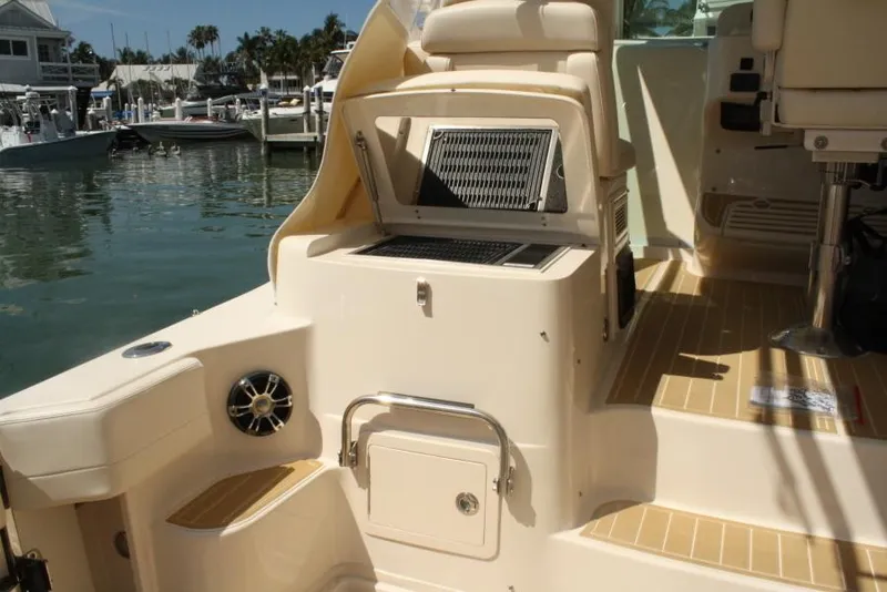 Slide: The Image of 2019 Grady-White Express boat interior with seating and storage at marina. - 17