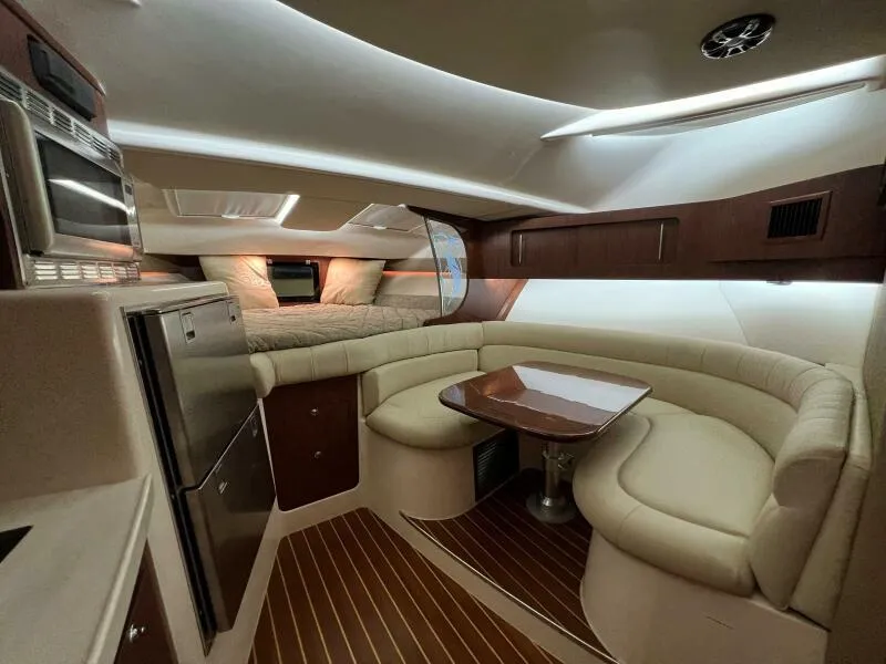 Slide: The Image of 2019 Grady-White Express boat interior with kitchen, dining area, and sleeping quarters. - 31