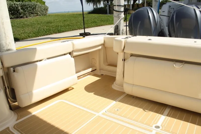 Slide: The Image of 2019 Grady-White Express boat interior with cushioned seating and twin outboard motors. - 7