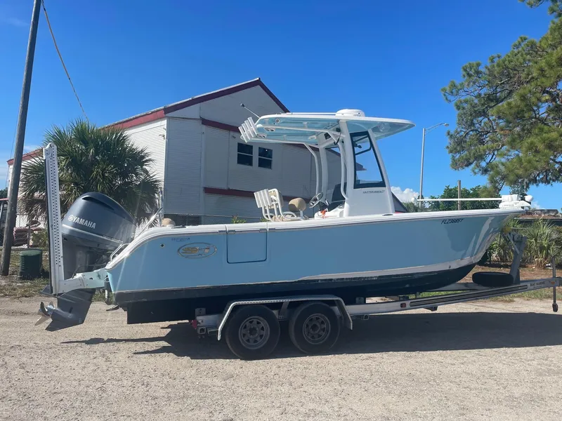 The Image of 2018 Sea Hunt Ultra 235 SE boat on a trailer with Yamaha outboard motor. - 0