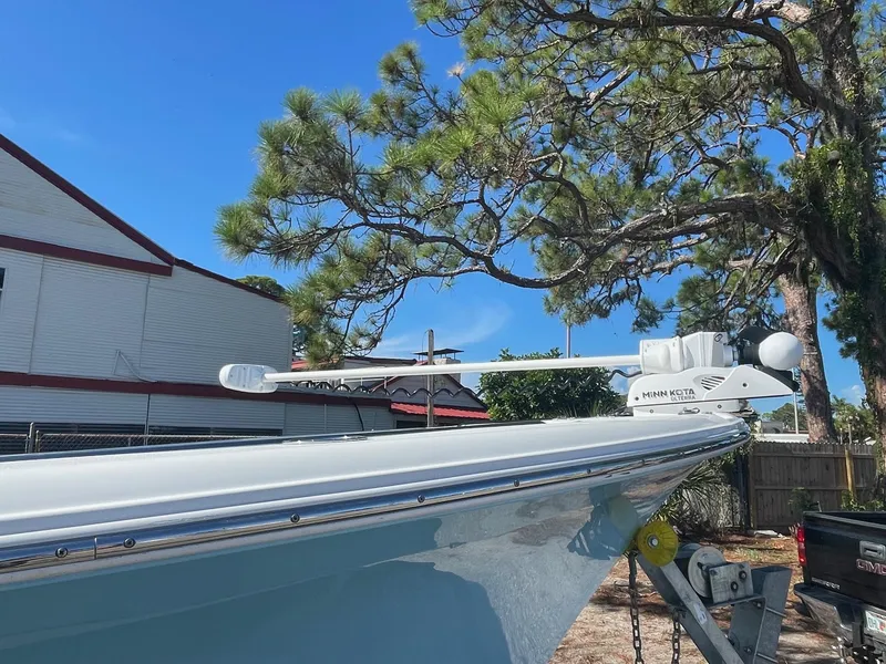 Slide: The Image of 2018 Sea Hunt Ultra 235 SE boat with radar, docked under clear blue sky. - 3