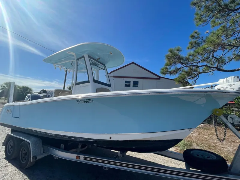 Slide: The Image of 2018 Sea Hunt Ultra 235 SE boat on a trailer under a clear blue sky. - 4