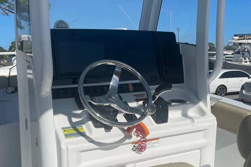 Slide: The Image of 2018 Sea Hunt Ultra 235 SE boat helm with steering wheel and control panel. - 8