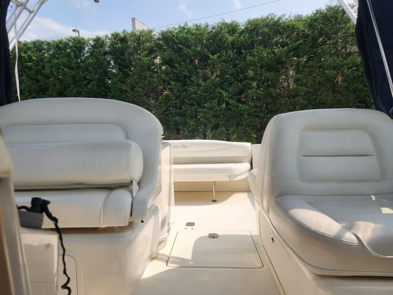 Slide: The Image of Interior of 2004 Sea Ray 290 Amberjack boat with white leather seating. - 16